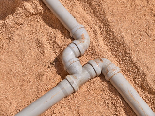 Junction of plastic sewer pipes. Sewage pipeline system of residential building under construction