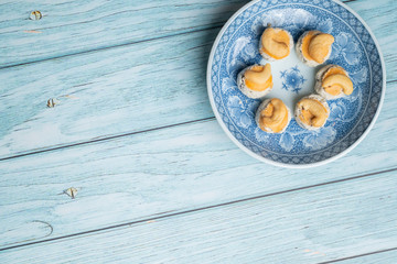 Thai Traditional Cookie on Blue Dish and Wooden Round Board with Blue Rustic Old Wooden Table