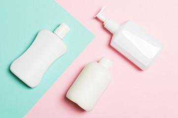 Set of White Cosmetic containers isolated on yellow background, top view with copy space. Group of plastic bodycare bottle containers with empty space for you design