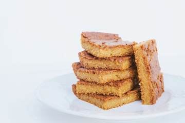 Blondie brownie dessert slices on white background, close up.