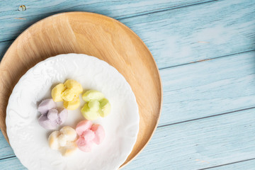 Thai Traditional Cookie on Blue Dish and Wooden Round Board with Blue Rustic Old Wooden Table