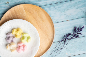 Thai Traditional Cookie on Blue Dish and Wooden Round Board with Blue Rustic Old Wooden Table