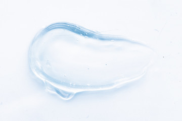 Fototapeta na wymiar Transparent liquid gel cream smudge on white background