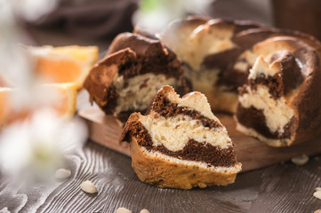 Fototapeta na wymiar Swirl cake with chocolate on wooden background