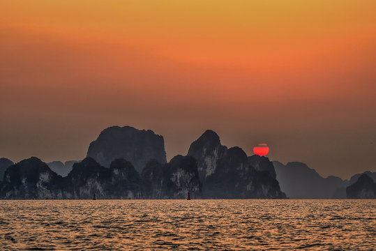 Aerial view floating fishing village and rock island, Halong Bay, Vietnam, Southeast Asia. UNESCO World Heritage Site. Junk boat cruise to Ha Long Bay. Popular landmark, famous destination of Vietnam