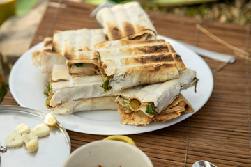 Making a lavash vegatarian rolls at a picknick outdoors.