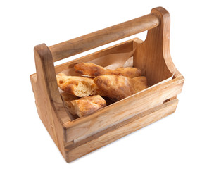 Hot slices of bread lie in a wooden box. 