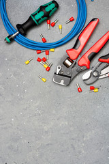 Tools and tips of different sizes and colors for crimping stranded electrical wires. Crimping...