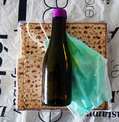 Corona Passover. Dust mask, bottle of wine and matzah - a traditional Jewish food for Passover