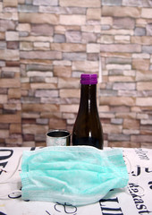 Corona Passover. Dust mask, bottle of wine and matzah - a traditional Jewish food for Passover