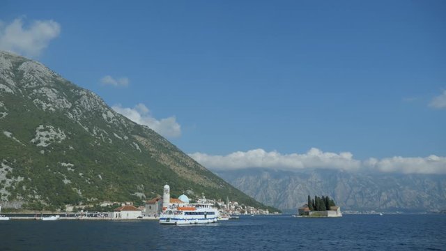 Beautiful view of cruise ship proceed on sailing from port channel in cotor bay near Montenegro in mountain background due middle day