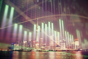 Naklejka premium Financial graph on night city scape with tall buildings background multi exposure. Analysis concept.