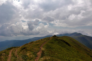 Fototapeta premium The road trough the mountains to the sky.