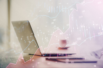 Double exposure of graph and financial info and work space with computer background. Concept of...