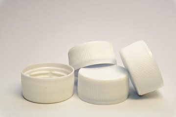 white plastic bottle stoppers on a white background 