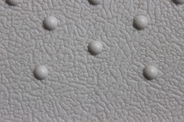White plastic panel with round dots. Macro. Russia.