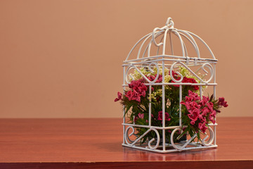 Bouquet of flowers, bird cage flower arrangement and vintage wedding decorations with burning candle