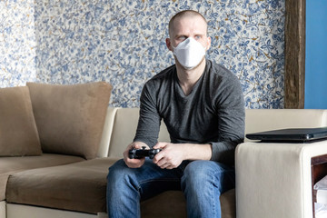 a young man with a ffp1 respirator in quarantine in his apartment during a pandemic of the...