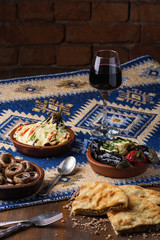 Vegetarian food concept. Set of healthy vegetarian food, salad, boiled, roasted, beans pie, greens and vegetables, stuffed eggplant, vegetables on a wooden table