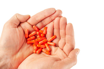 Man's hands isolated on white background with vitamin pills