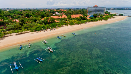 Aerial view of traditional balinese fishing boats in lagoon at anchor.