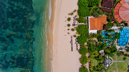 Top view on recreation area with umbrellas on the beach. Aerial view.