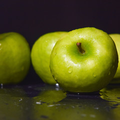 ripe green apples are covered with water drops