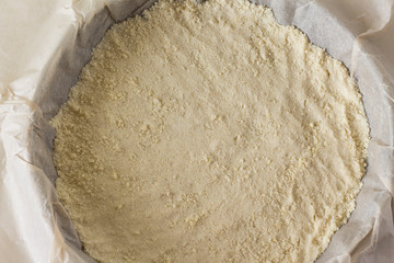 put the ready crumbly shortbread dough in a form on parchment