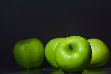 ripe green apples are covered with water drops