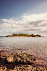 Landscape with Alcanada Lighthouse (Faro de Alcanada), color toning applied, Mallorca, Spain.