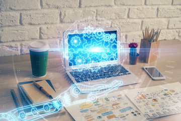 Double exposure of desktop computer and technology theme hologram. Concept of software development.