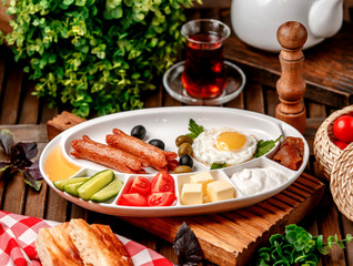 breakfast set with fried sausages eggs and vegetables