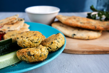 Traditional homemade falafel cooked from chickpeas, garlic and parsley, served with fresh vegetables and yogurt. Healthy and delicious food concept