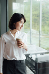 An Asian business woman with short hair is working
