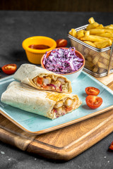 burito with chicken and tomato on the table