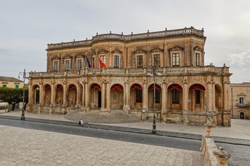 Fototapeta na wymiar The Palazzo Ducezio in Noto, Sicily, Italy with a rounded staircase in front of the entrance and no people