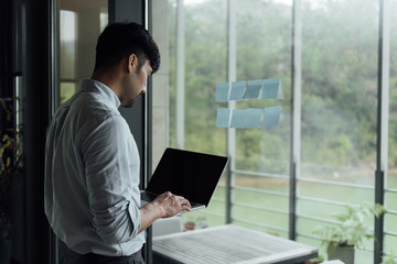 A young Asian business man is working