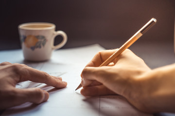 Hands draw a storyboard for the film indoors.