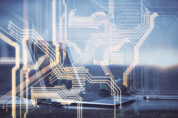 Computer on desktop in office with technology theme hologram. Multi exposure. Tech concept.