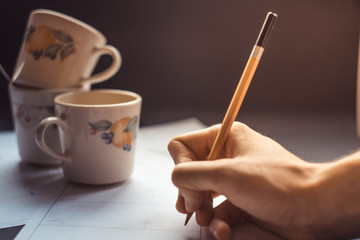 Hands draw a storyboard for the film indoors.