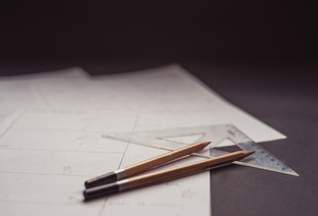 drawing a storyboard for the film indoors.