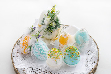 Easter composition of eggs in a basket, handmade, prepared for the holiday of Easter, on a white background