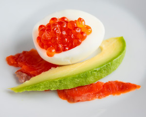 egg with red caviar, chum salmon and avocado slices
