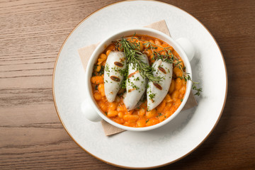 Beautiful serving dish with legumes and meat on wood background. Grill, soup, healthy food, food, rosemary, restaurant