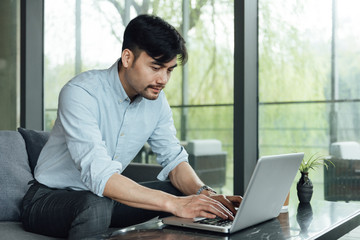 A young Asian business man is working