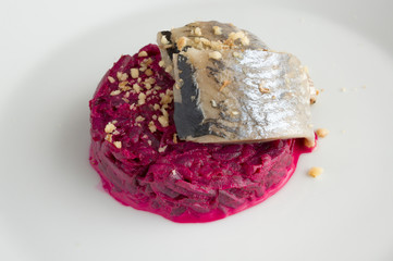 mayo based beet garlic salad accompanied with freshly salted herring sprinkled with walnut crumbs
