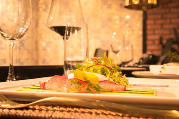 Table setting in a restaurant for dinner. Glasses, food, decor, table, drink