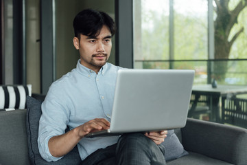 A young Asian business man is working