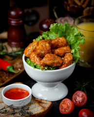 chicken in sauce in a white bowl on the table