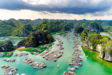 Floating fishing village and rock island in " Lan Ha " Bay, Vietnam, Southeast Asia. UNESCO World Heritage Site. Landscape. Popular landmark, famous destination of Vietnam. Near " Ha Long " bay © Hien Phung